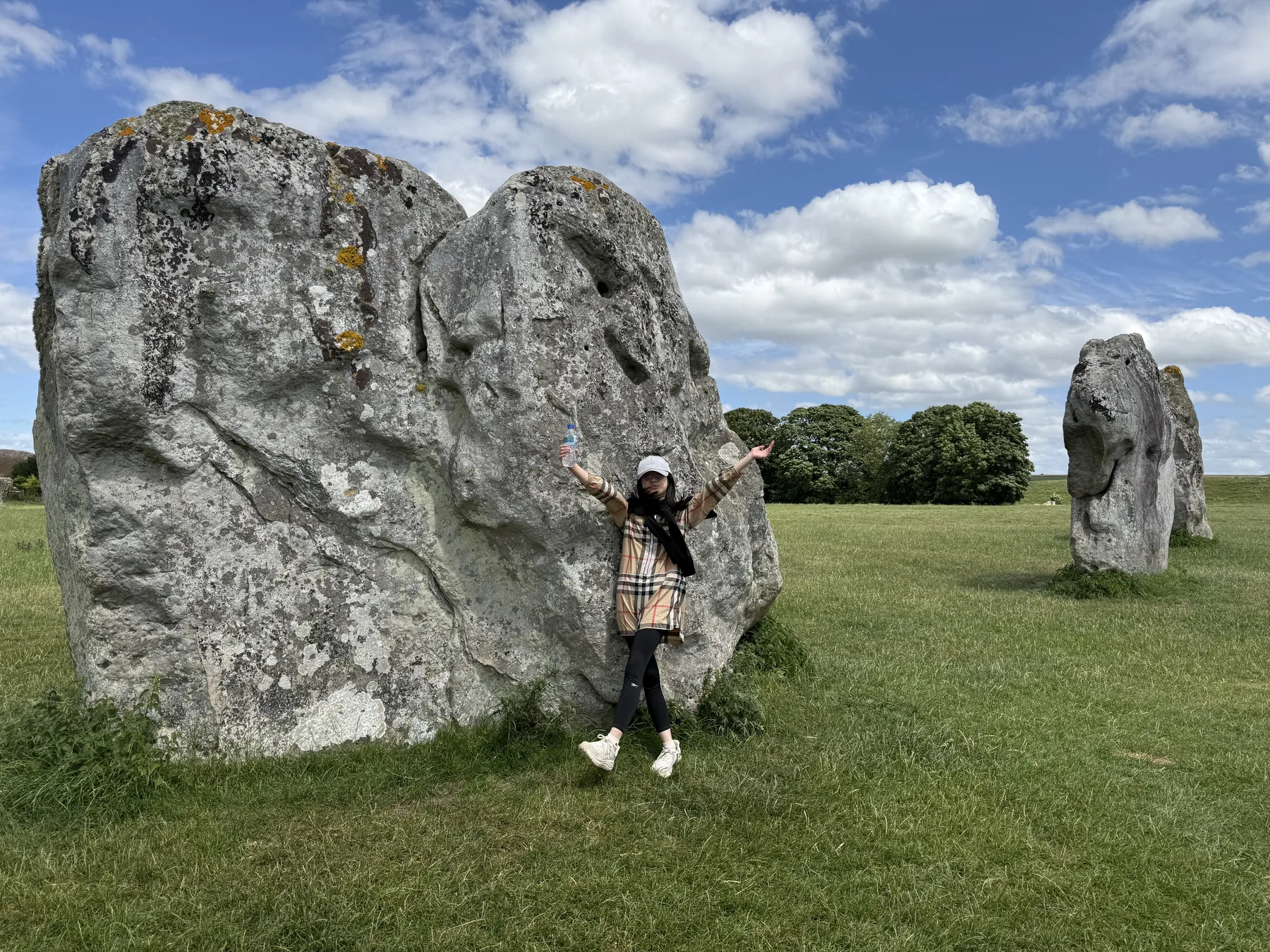 Standing beside one of the enormous stones.